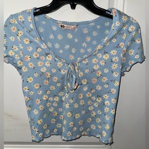 I am selling a flowered shirt that is light blue